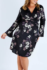 Model Fiona wearing size 16 of The Define Printed Wrap Dress in colour Floral (Black), from the front, cropped image