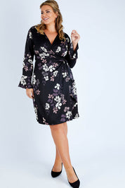 Model Fiona wearing size 16 of The Define Printed Wrap Dress in colour Floral (Black), from the front, showing the whole outfit
