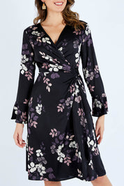 Model Madeline wearing size 10 of The Define Printed Wrap Dress in colour Floral (Black), from the front, cropped image