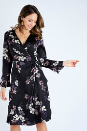 Model Madeline wearing size 10 of The Define Printed Wrap Dress in colour Floral (Black), from the front, cropped image