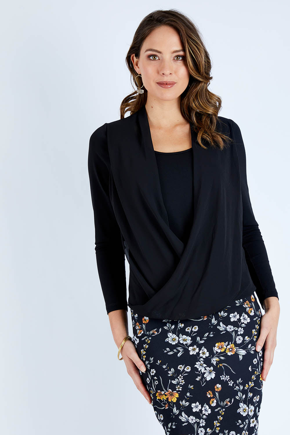 Model Madeline wearing size 10 of The Faux 2 Piece Crossover Top in colour Black (Black), from the front, cropped image