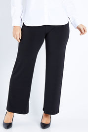 Model Laura wearing size 12 of The Wide Waistband Basic Pull On Pant in colour Black (Black), from the front, cropped image