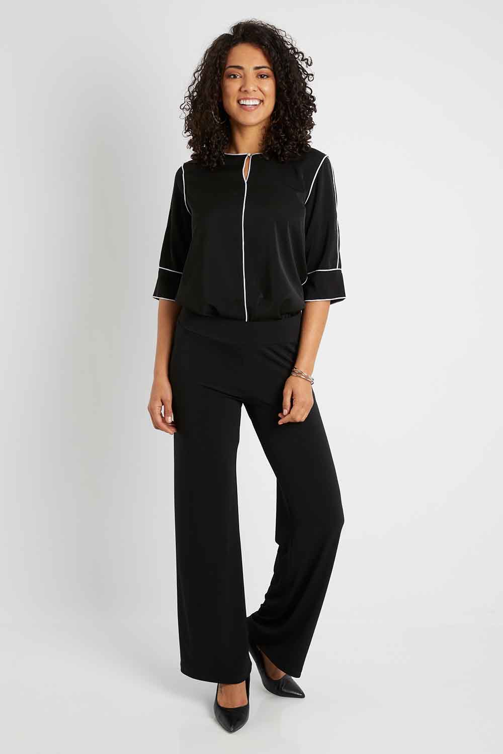 Model Pamela wearing size 10 of The Wide Waistband Basic Pull On Pant in colour Black (Black), from the front, showing the whole outfit