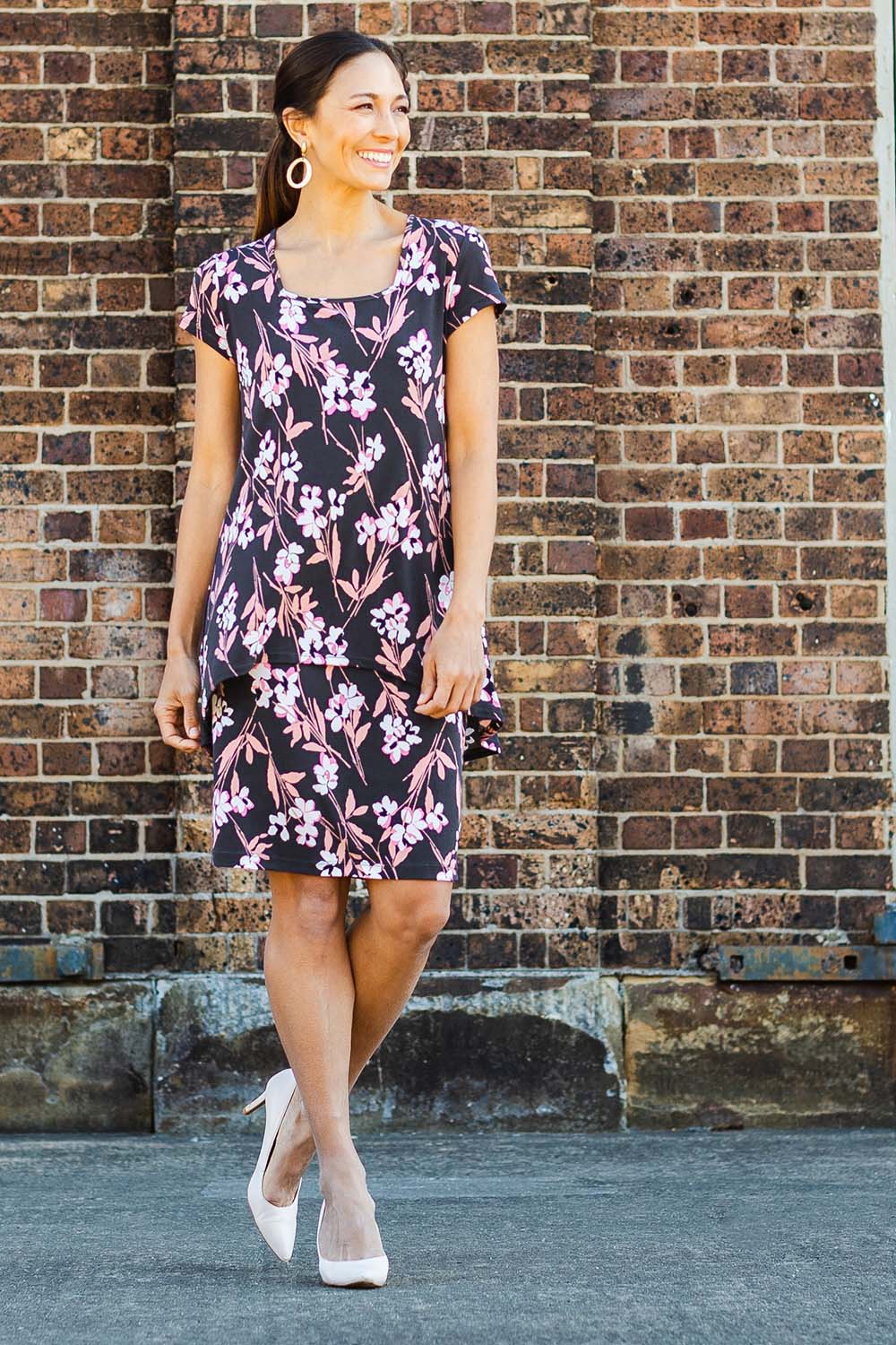 Model Cara wearing size 10 of The Printed Short Sleeve Rita Dress in colour Blooms (Grey), from the front, showing the whole outfit