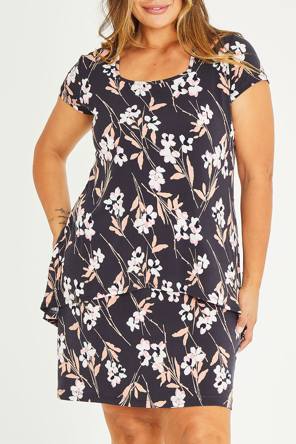 Model Palatina wearing size 16 of The Printed Short Sleeve Rita Dress in colour Blooms (Grey), from the front, cropped image