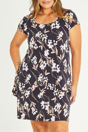 Model Palatina wearing size 16 of The Printed Short Sleeve Rita Dress in colour Blooms (Grey), from the front, cropped image