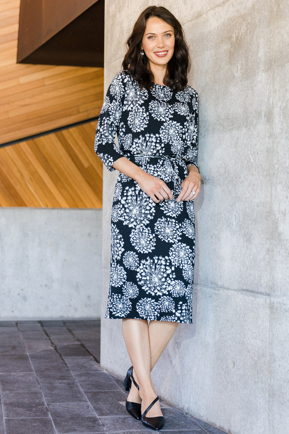 Model Andrea wearing size 10 of The Lined Jersey Dress in colour Blooms (Black), from the front, showing the whole outfit