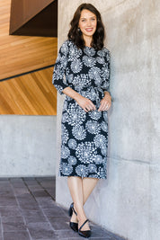 Model Andrea wearing size 10 of The Lined Jersey Dress in colour Blooms (Black), from the front, showing the whole outfit