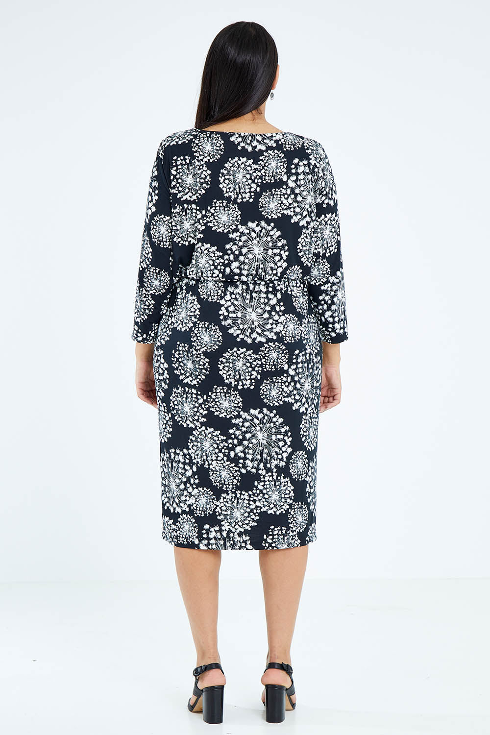 Model Sasha-Lee wearing size 16 of The Lined Jersey Dress in colour Blooms (Black), from the back