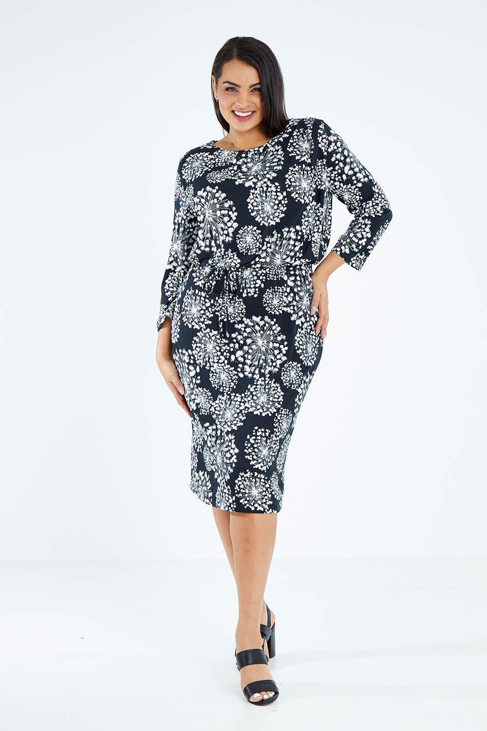 Model Sasha-Lee wearing size 16 of The Lined Jersey Dress in colour Blooms (Black), from the front, showing the whole outfit