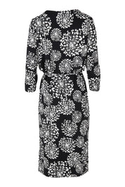 Product shot of The Lined Jersey Dress in colour Blooms (Black), from the back