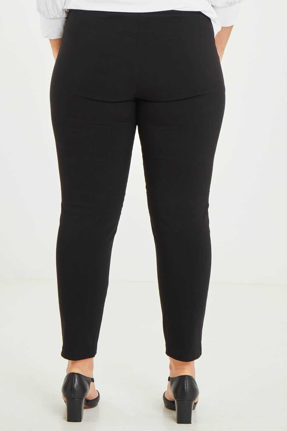 Model Katie wearing size 16 of The Stretch Career Pull On Pant in colour Black (Black), from the back
