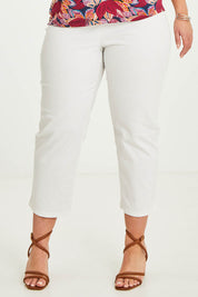 Model Katie wearing size 16 of The Cotton Stretch Pull On Pant in colour Pearl (White), from the front, cropped image