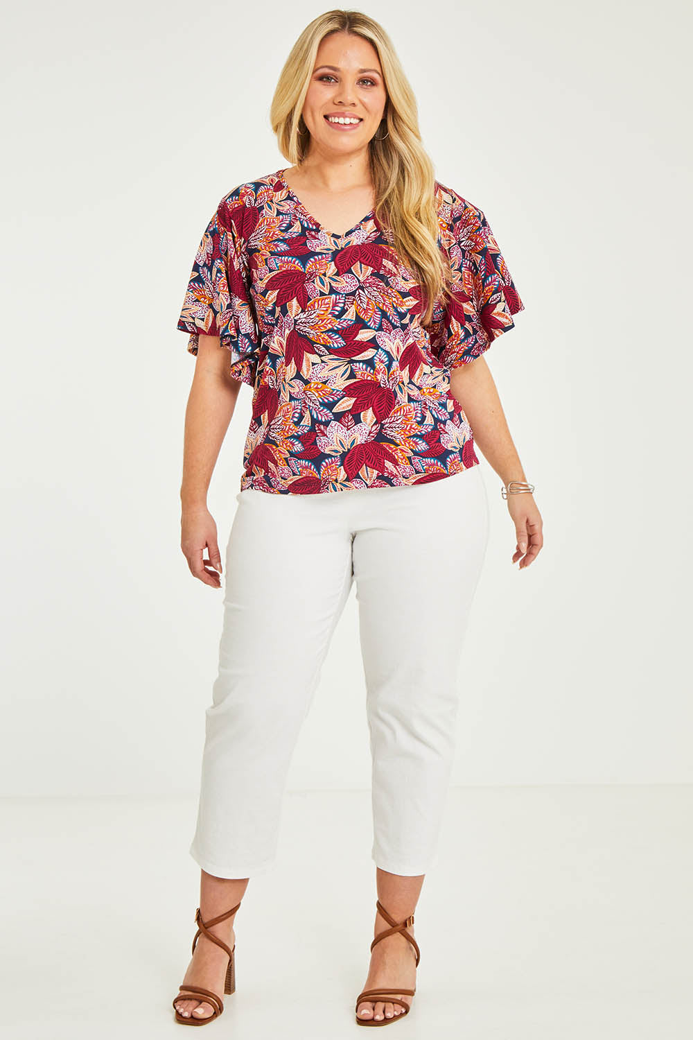 Model Katie wearing size 16 of The Cotton Stretch Pull On Pant in colour Pearl (White), from the front, showing the whole outfit
