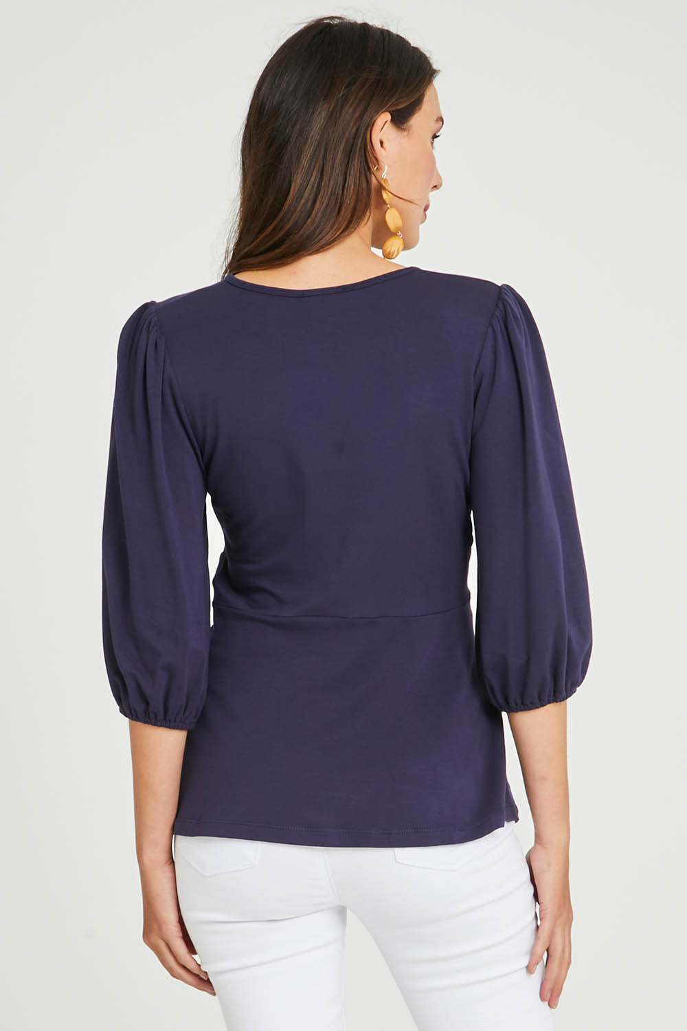 Model Madeline wearing size 10 of The Bamboo Knot Waist Detail Blouse in colour Darknavy (Blue), from the back