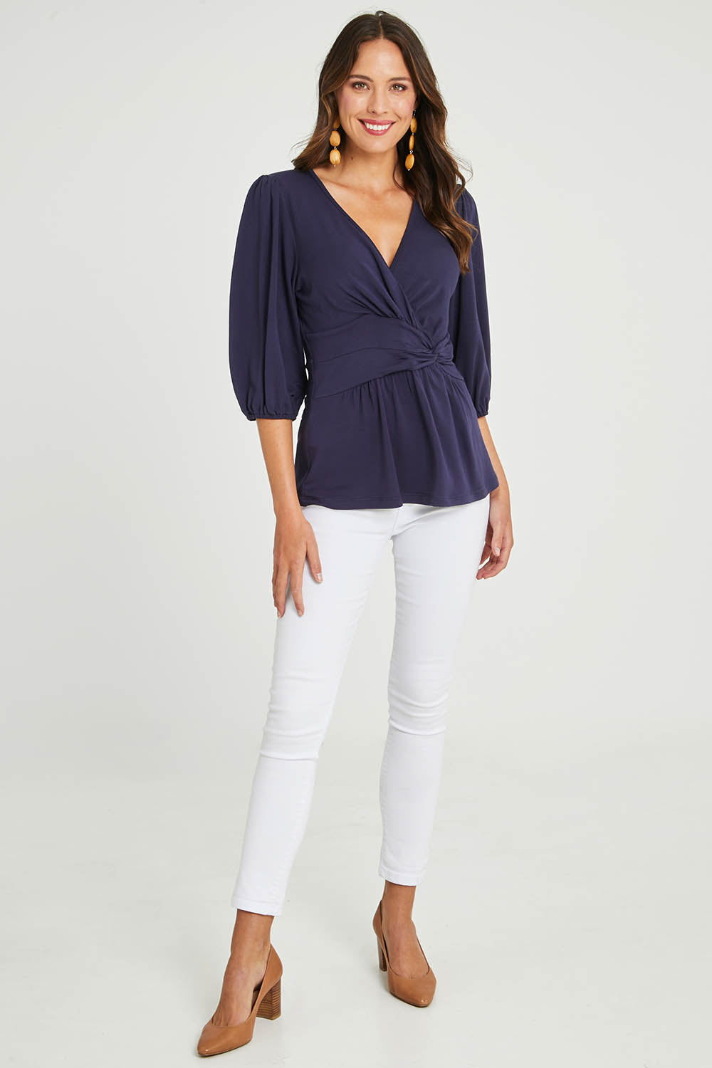 Model Madeline wearing size 10 of The Bamboo Knot Waist Detail Blouse in colour Darknavy (Blue), from the front, showing the whole outfit