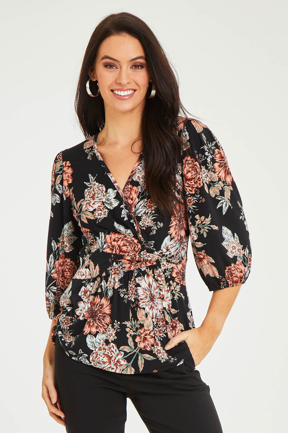 Model Stacey wearing size 10 of The Knot Waist Detail Blouse in colour Blackfleur (Black), from the front, cropped image