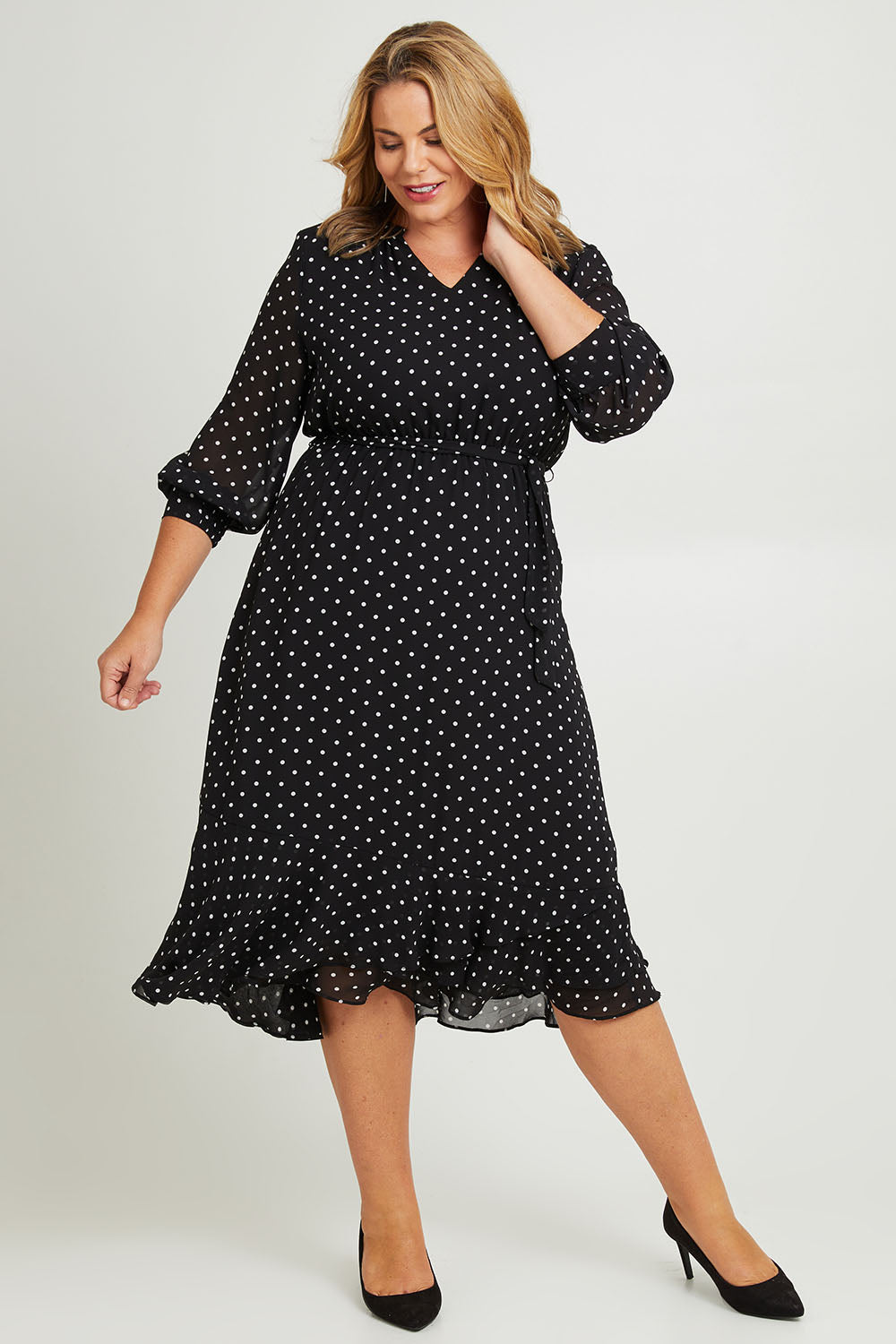 Model Fiona wearing size 16 of The Printed Chiffon Puff Sleeve Dress in colour Polkadot (Black), from the front, showing the whole outfit