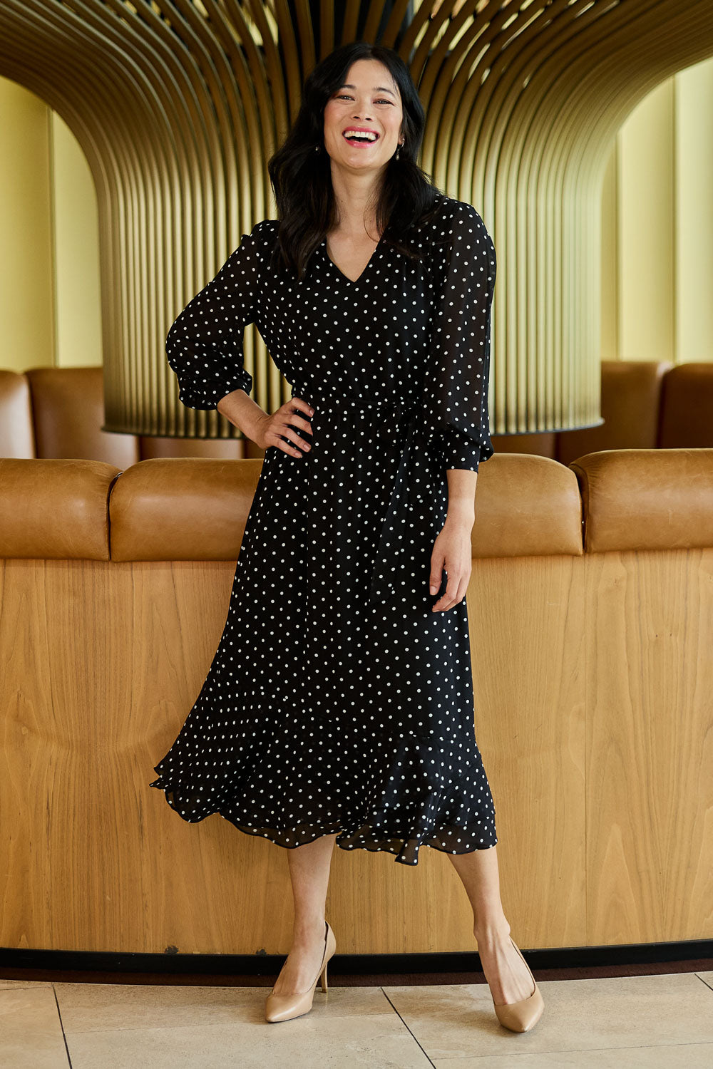 Model Miranda wearing size 10 of The Printed Chiffon Puff Sleeve Dress in colour Polkadot (Black), from the front, showing the whole outfit