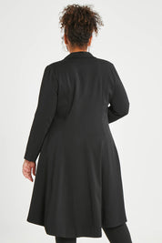 Model Alexis wearing size 16 of The Tailored Longline Jacket in colour Black (Black), from the back