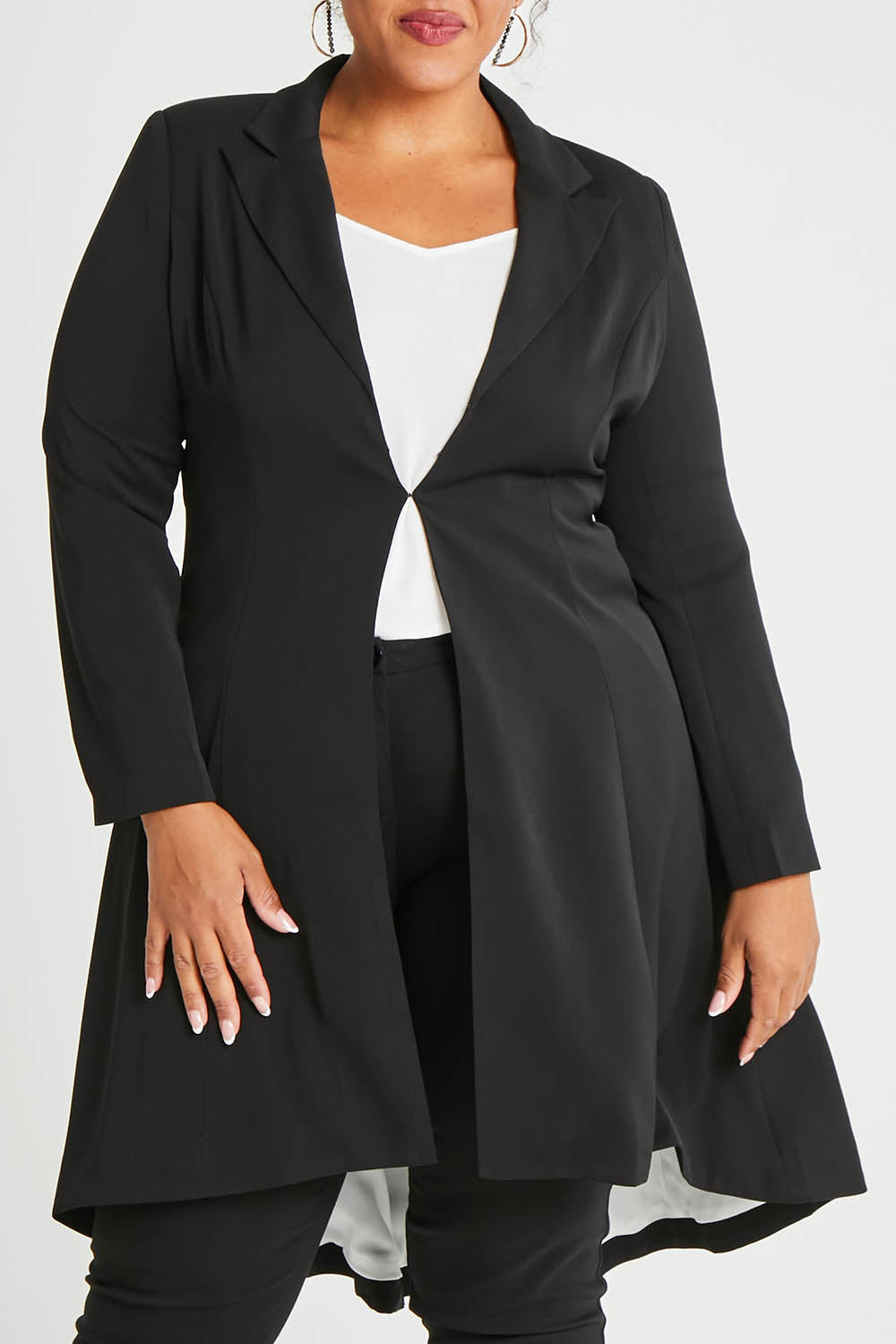 Model Alexis wearing size 16 of The Tailored Longline Jacket in colour Black (Black), from the front, cropped image