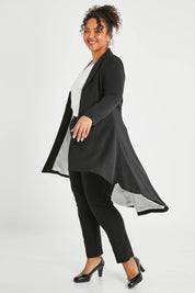 Model Alexis wearing size 16 of The Tailored Longline Jacket in colour Black (Black), from the front, showing the whole outfit