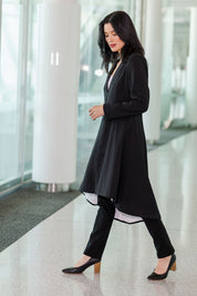 Model Miranda wearing size 10 of The Tailored Longline Jacket in colour Black (Black), from the front, showing the whole outfit