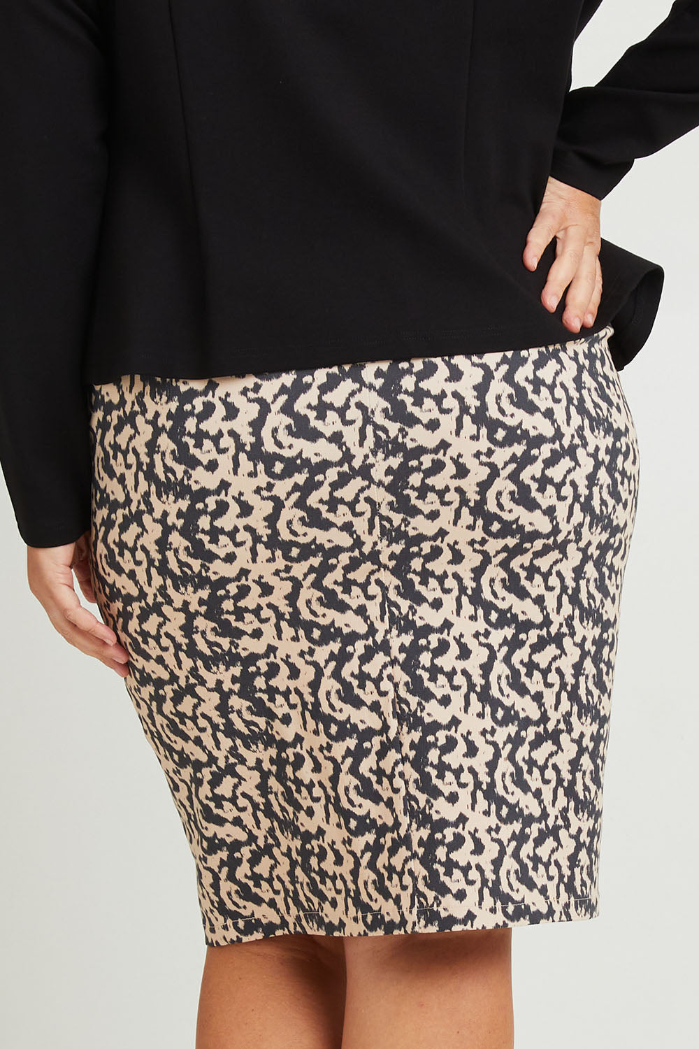 Model Fiona wearing size 16 of The Tube Skirt in colour Inkblot, from the back