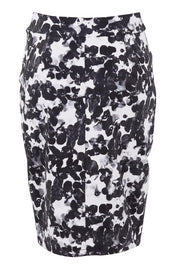 Product shot of The Tube Skirt in colour Floral (Black), from the back