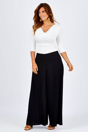 Model Laura wearing size 12 of The Reversible Cowl Neck Top in colour White (White), from the front, showing the whole outfit