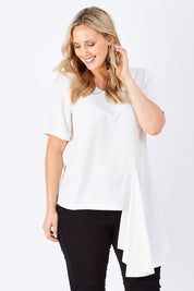 Model Jess wearing size 14 of The Side Panel Drape Top in colour OffWhite (White), from the front, cropped image