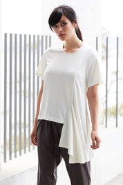 Model Miranda wearing size 10 of The Side Panel Drape Top in colour OffWhite (White), from the front, showing the whole outfit