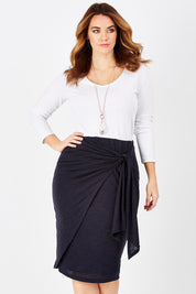 Model Laura wearing size 12 of the Belle Tie Front Skirt in colour Navy (Blue), from the front, cropped image
