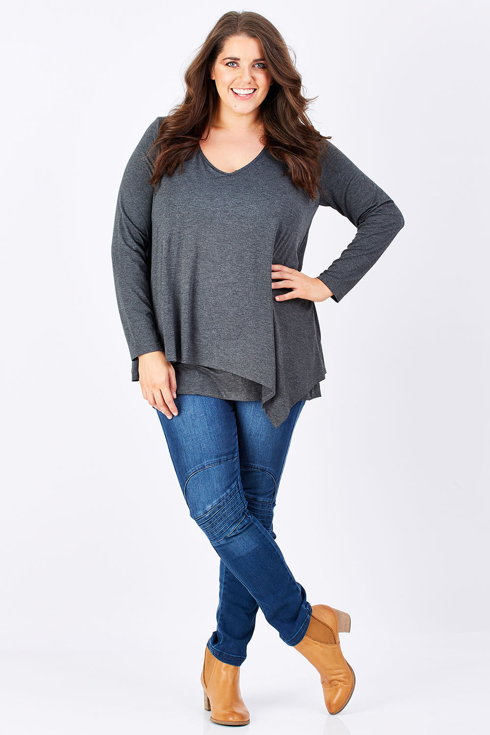 Model Mae wearing size 16 of the Belle V Neck Forgiver Tunic in colour Charcoal (Grey), from the front, showing the whole outfit