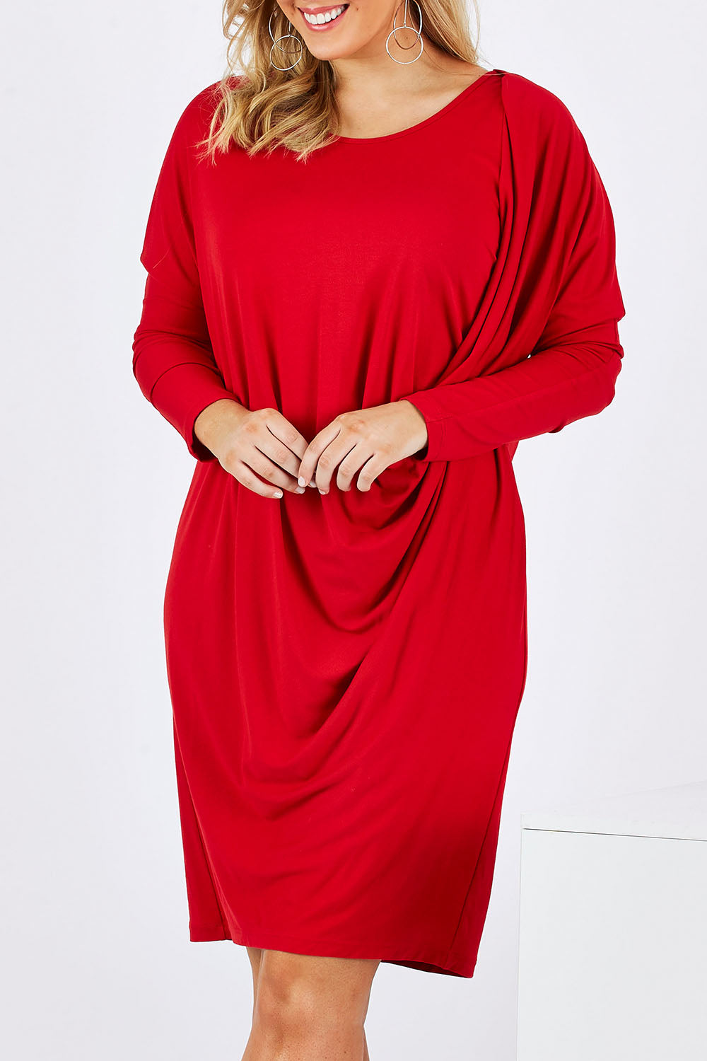 Model Jess wearing size 12 of the Belle Jersey Drapey Dress in colour Red (Red), from the front, cropped image