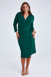 Model Monique wearing size 14 of the Belle Basic Wrap Dress in colour Pine (Green), from the front, showing the whole outfit