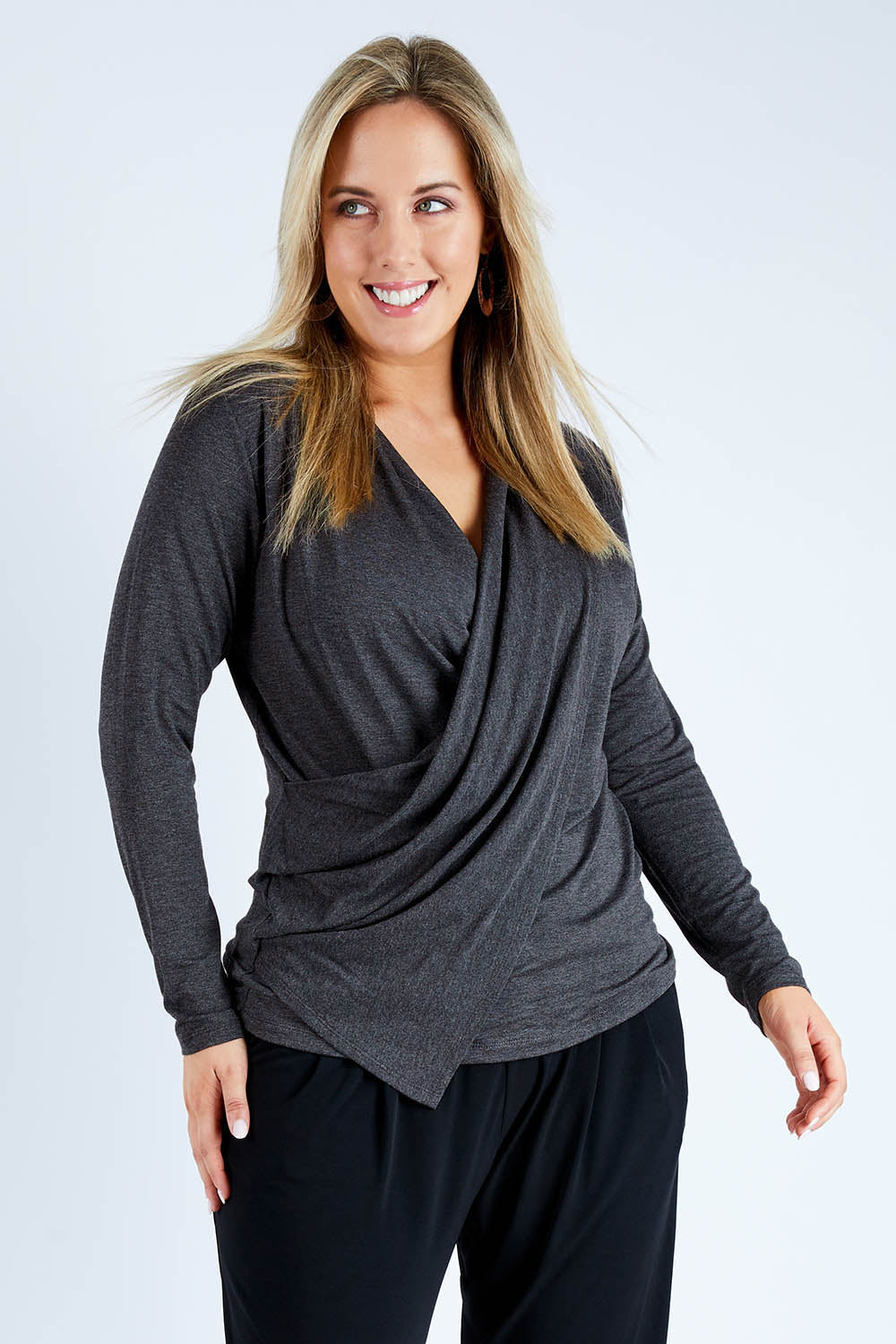 Model Jess wearing size 12 of the Belle Drape Top in colour Charcoal (Grey), from the front, cropped image