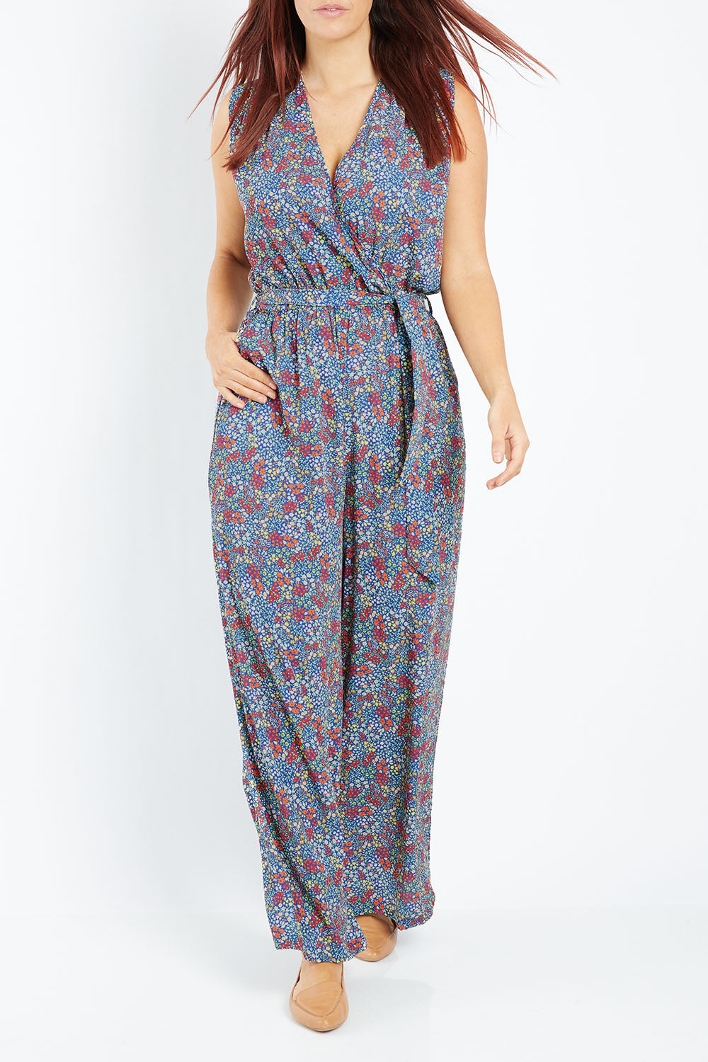 Model Laura wearing size 12 of the Belle Ditsy Floral Jumpsuit in colour Ditsyflora (Blue), from the front, cropped image