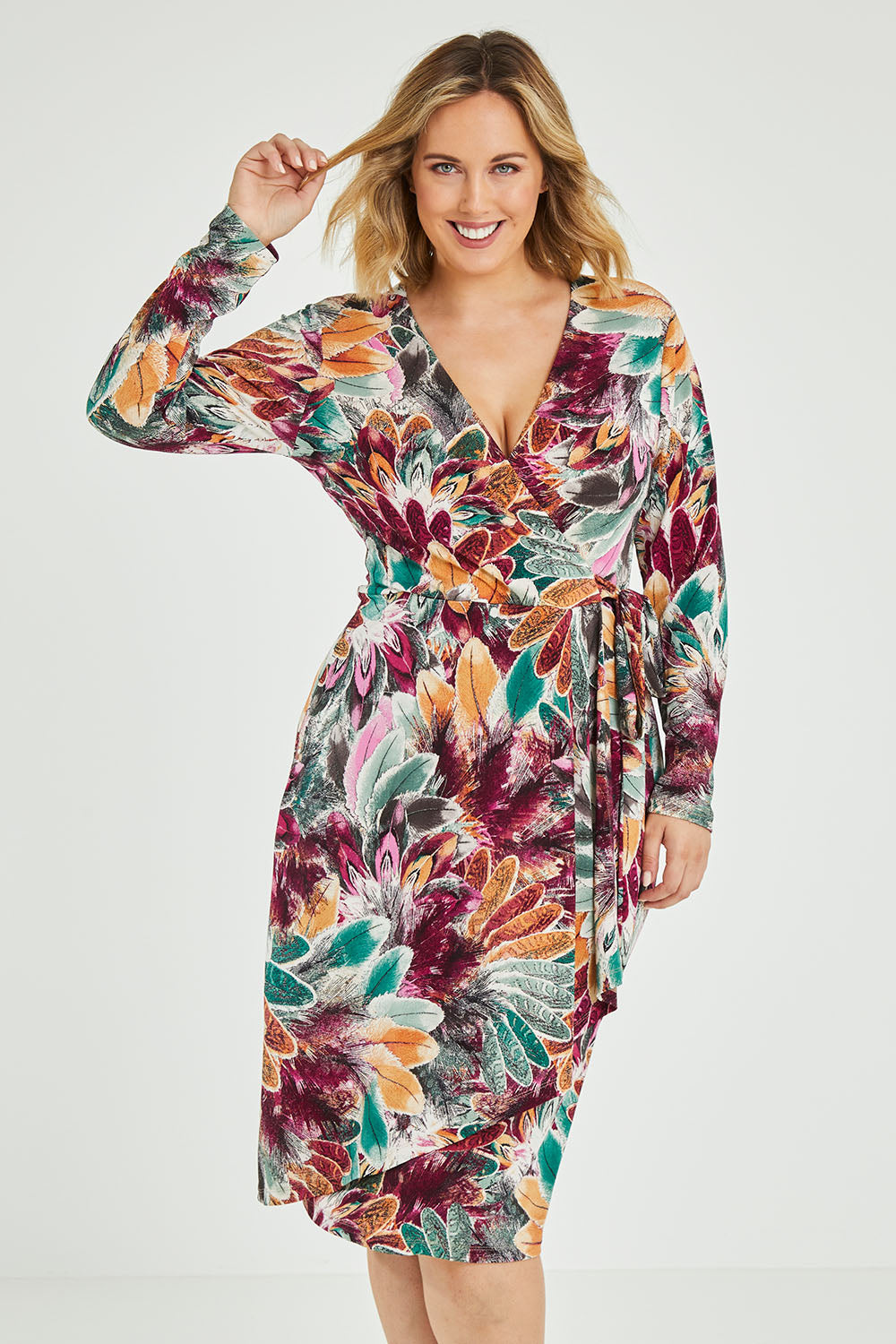 Model Jess wearing size 12 of the Belle Feather Print Wrap Dress in colour Feather (Green), from the front, cropped image