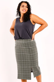 Model Sasha-Lee wearing size 16 of the Belle Check Cotton Rich Pencil Skirt in colour Check (Green), from the front, cropped image