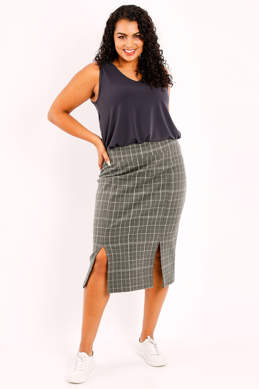 Model Sasha-Lee wearing size 16 of the Belle Check Cotton Rich Pencil Skirt in colour Check (Green), from the front, showing the whole outfit