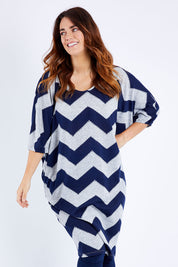 Model Laura wearing size 12 of the Belle Chevron Relaxed Knit Dress in colour Navychev (Blue), from the front, cropped image