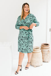 Model Palatina wearing size 16 of the Belle Bird Print Wrap Dress in colour Bird (Green), from the front, showing the whole outfit