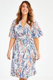 Model Laura wearing size 12 of the Belle Scatter Floral Kimono Sleeve Dress in colour Scatfloral, from the front, cropped image