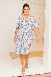 Model Palatina wearing size 16 of the Belle Scatter Floral Kimono Sleeve Dress in colour Scatfloral, from the front, showing the whole outfit