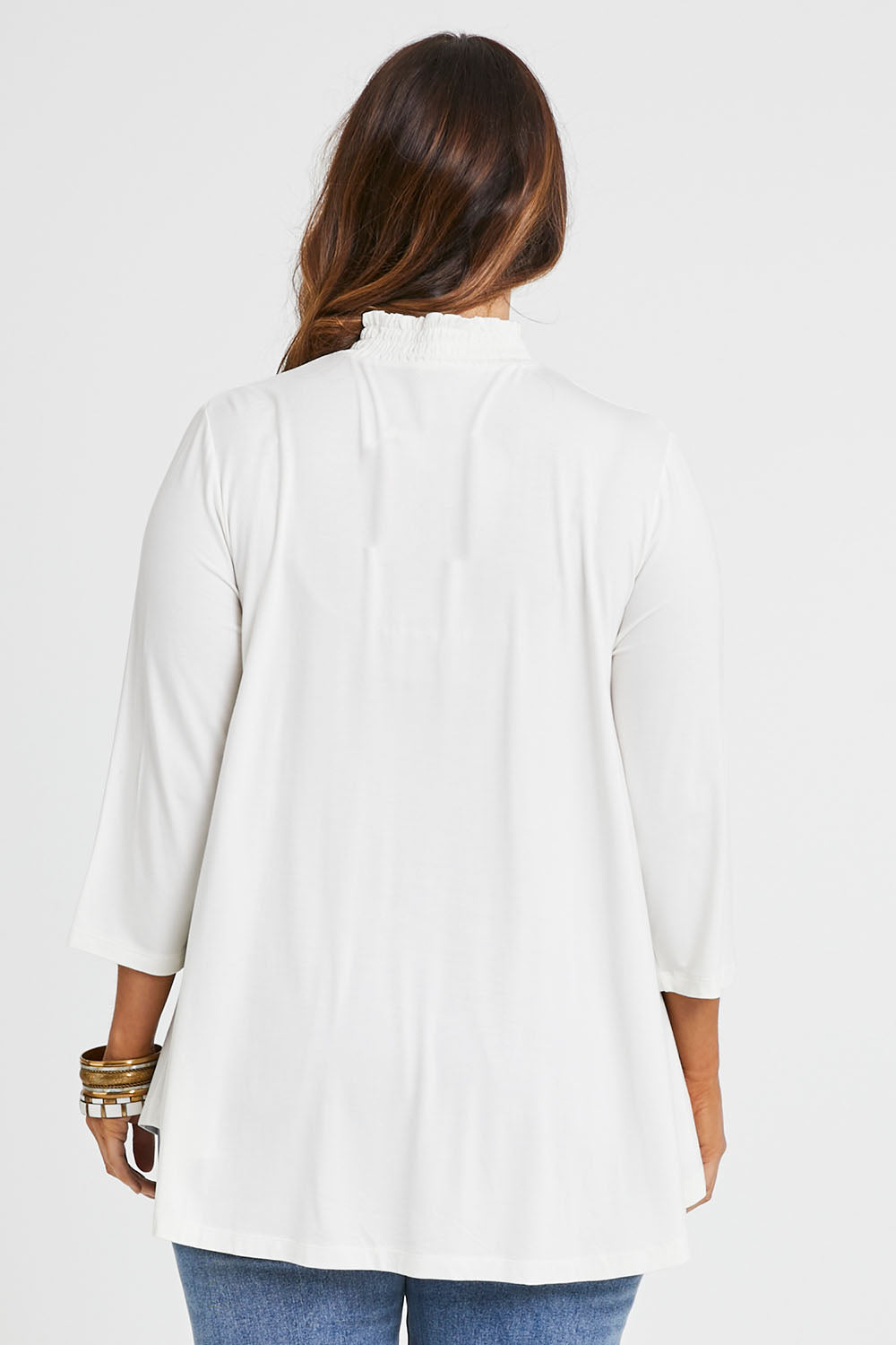Model Laura wearing size 14 of the Belle Turtleneck Draped Bamboo Tee in colour Ivory (White), from the back