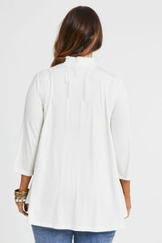 Model Laura wearing size 14 of the Belle Turtleneck Draped Bamboo Tee in colour Ivory (White), from the back