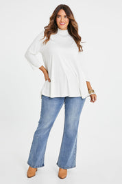 Model Laura wearing size 14 of the Belle Turtleneck Draped Bamboo Tee in colour Ivory (White), from the front, showing the whole outfit