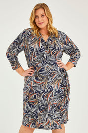Model Caitlin wearing size 20 of the Belle Classic Lined Wrap Jersey Dress in colour Navyprint (Blue), from the front, cropped image