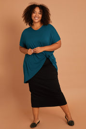 Model Alexis wearing size 16 of the Belle High Low Bamboo Tee in colour Petrol (Blue), from the front, showing the whole outfit